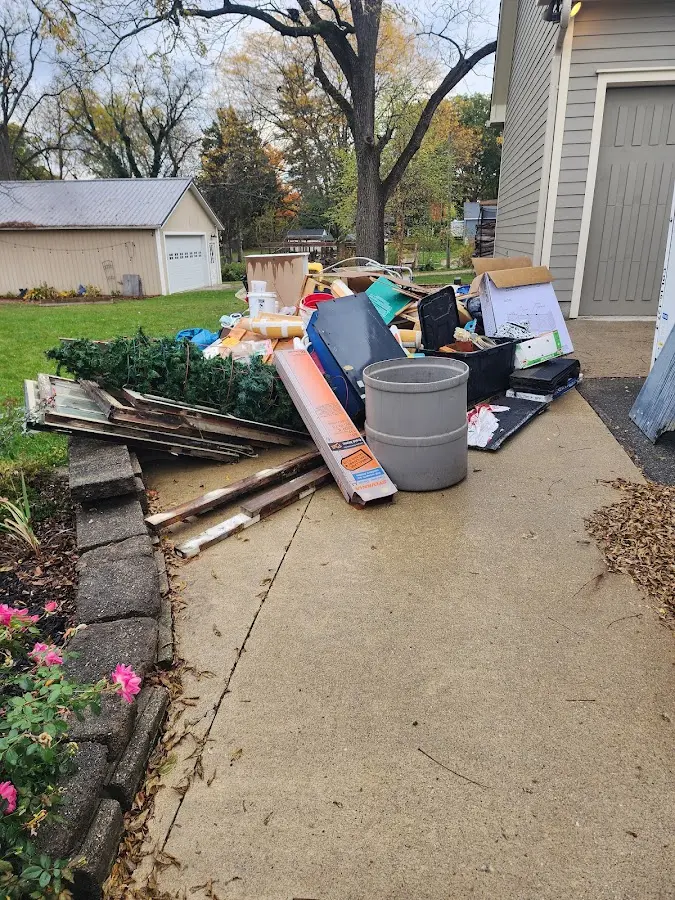 Dumpster being loaded with debris for Estate Cleanout Dumpster Rental in Coos Bay